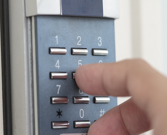 Opening the door with number combination Opening the door with number combination with woman hand.